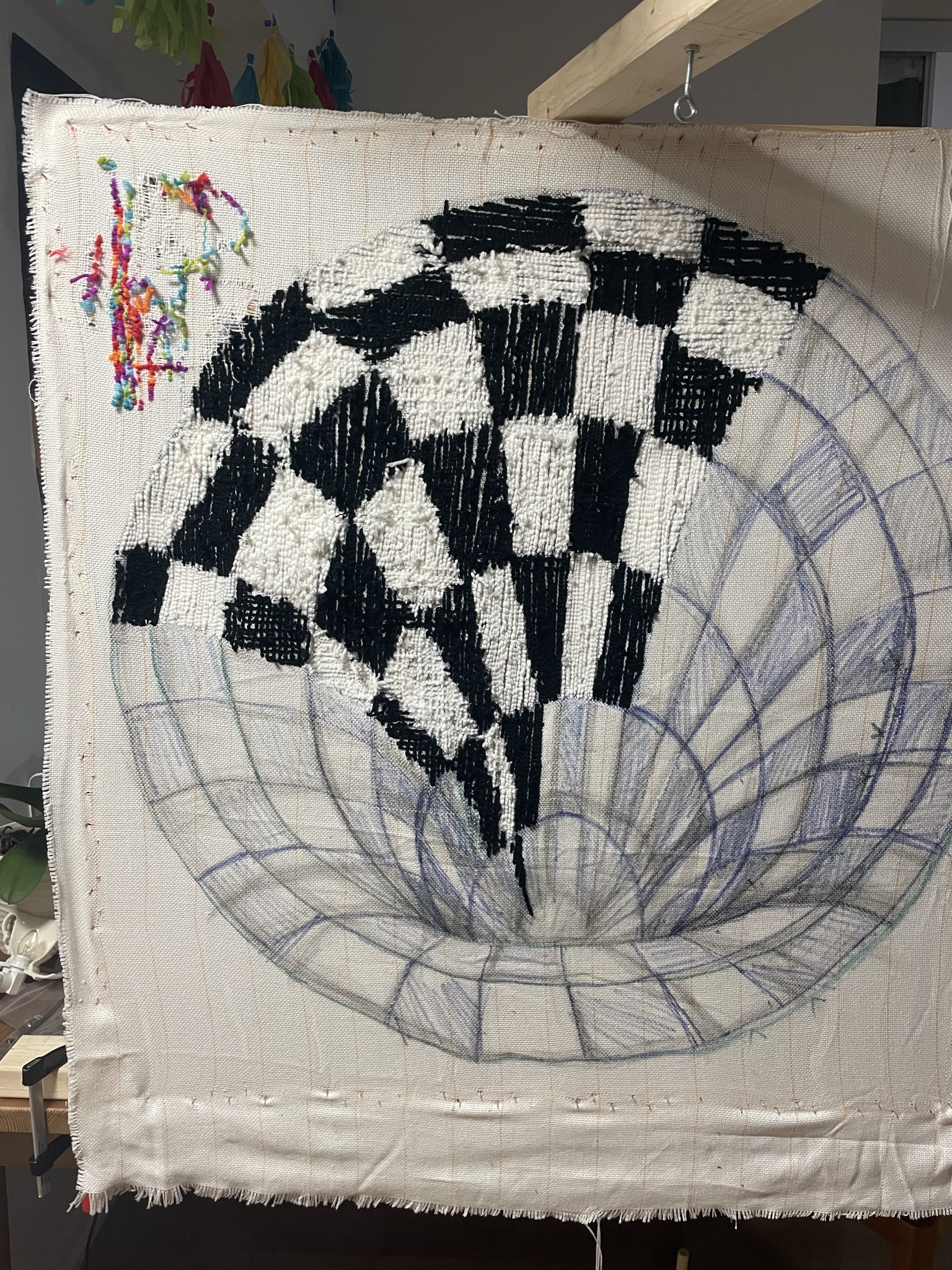 Work in progress of my first carpet, the sketches were drawn onto the canvas with the aid of a projector. The rainbow in the corner was me testing the machine before I started my first project with it